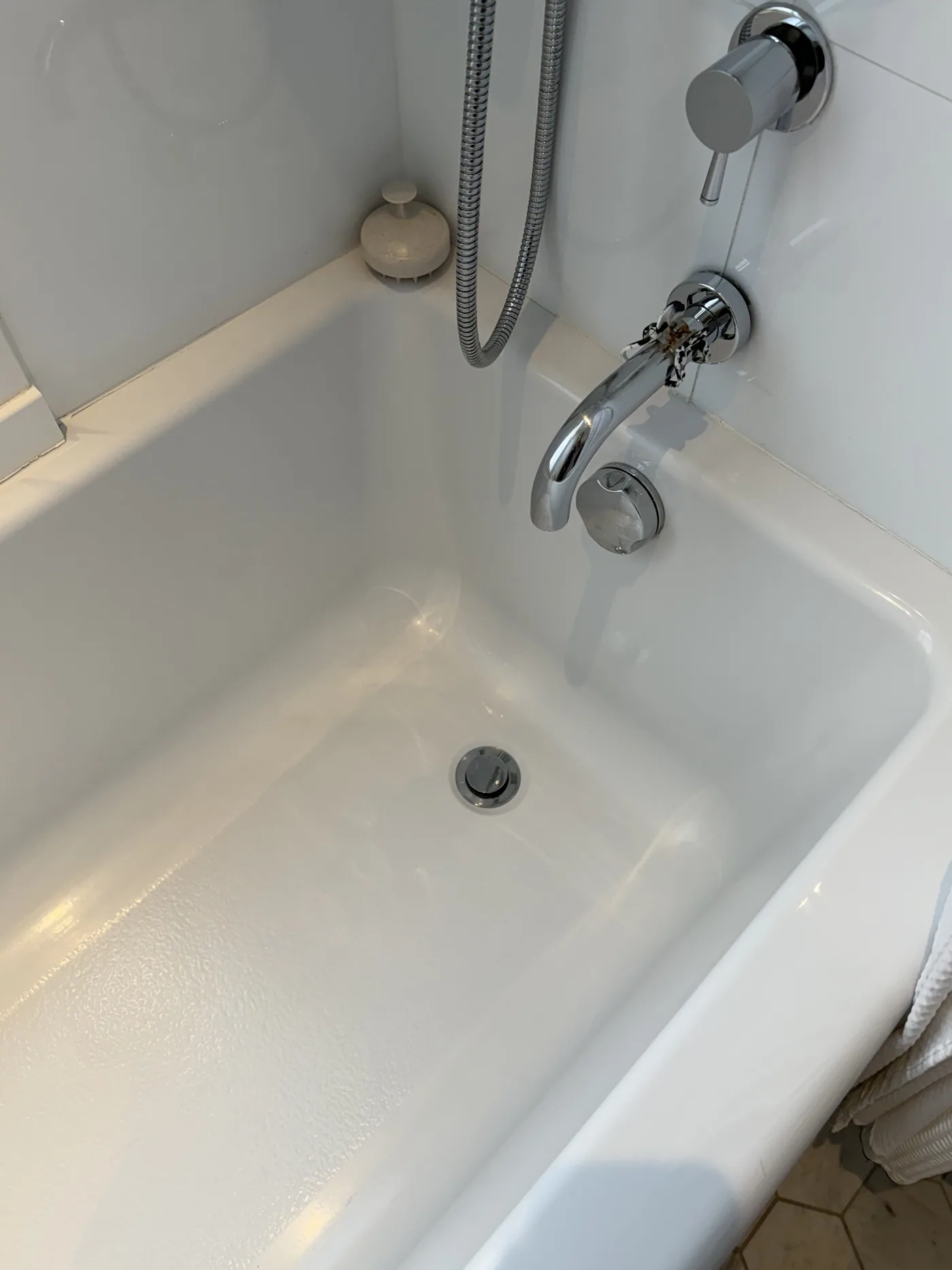 After: spotless white bathtub with polished chrome fixtures