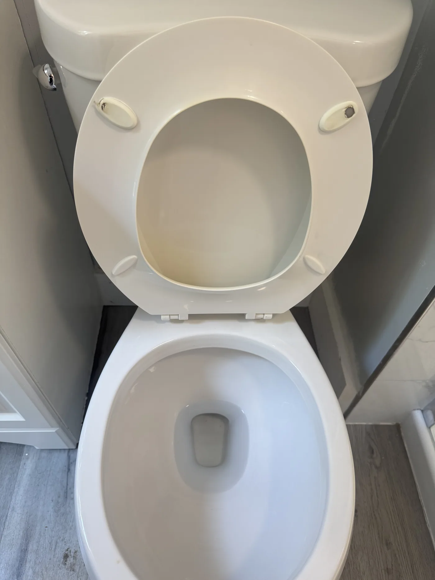 After: scrubbed toilet with a clean bowl, seat and surrounding floor